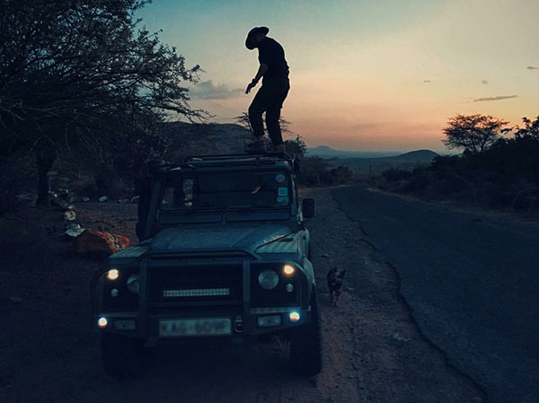 Trying to close the top of the Land Rover in Kenya. Photographed by Bret Hartman